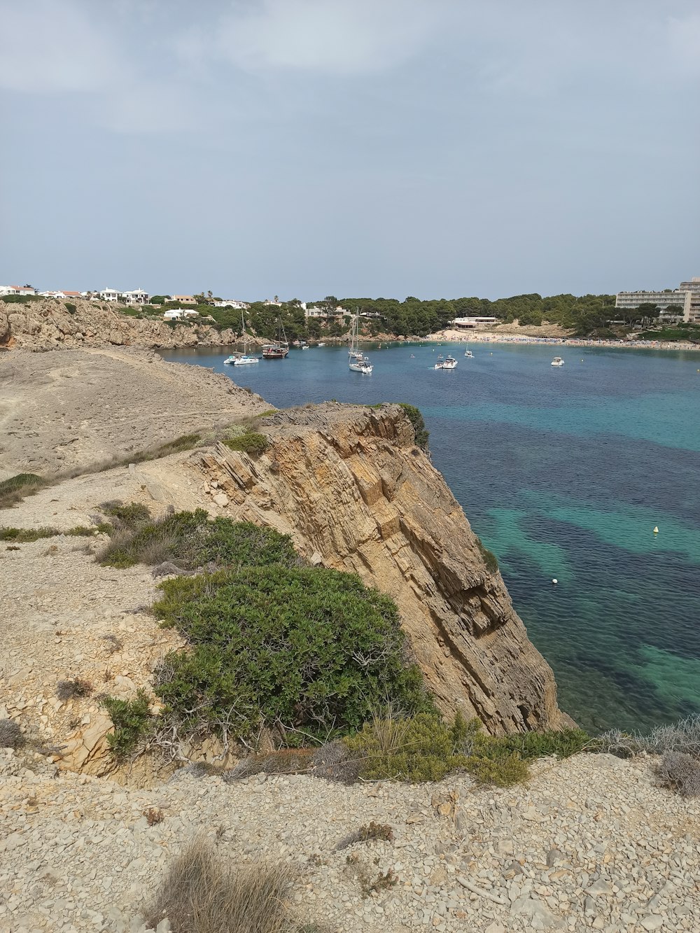 a rocky beach with boats