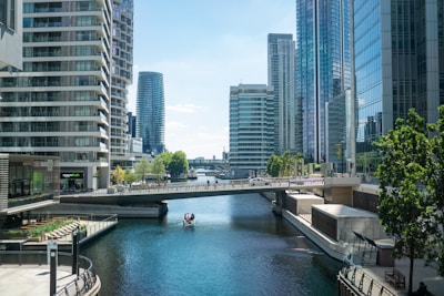 a river with a bridge and buildings