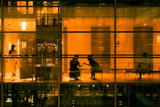 a reflection of a man and woman in a glass room