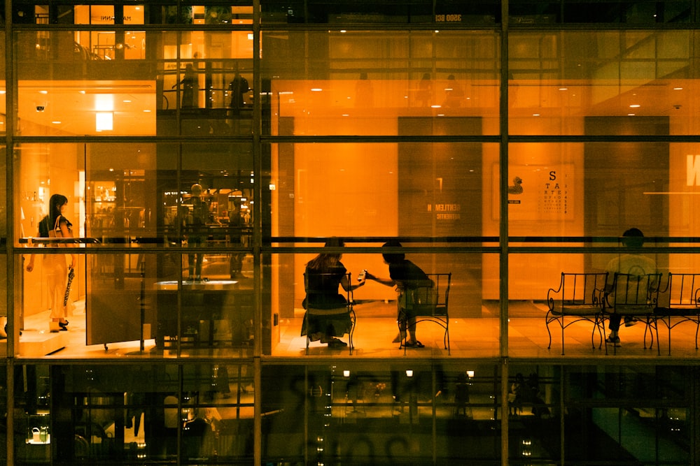 a reflection of a man and woman in a glass room