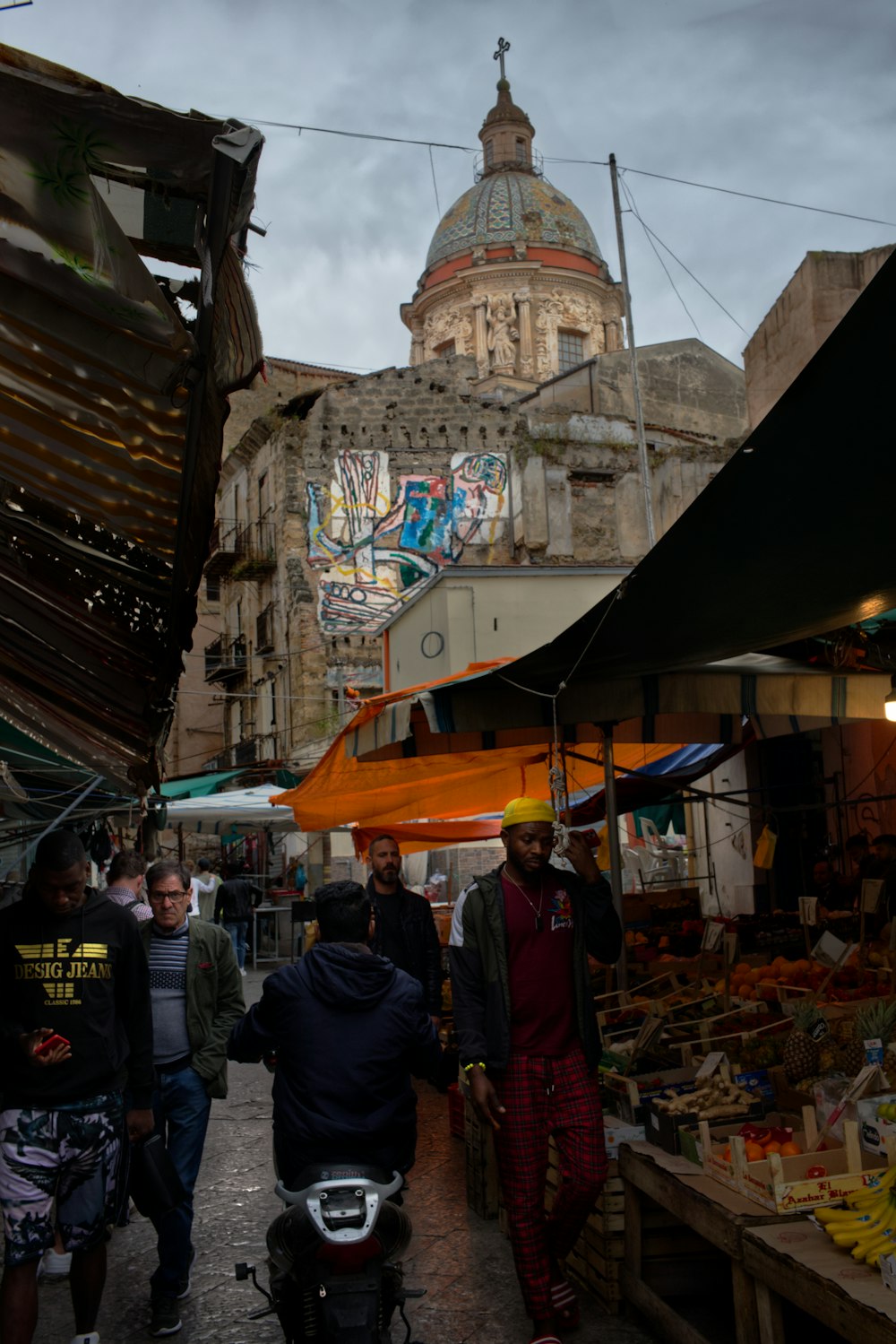 a group of people walking through a market