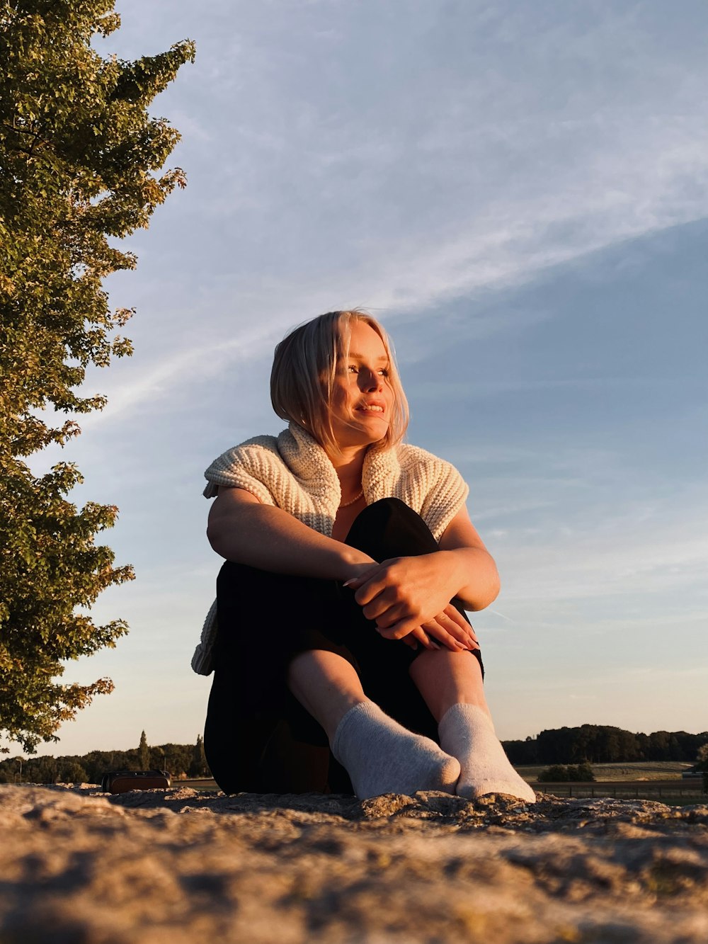 a person sitting on a rock