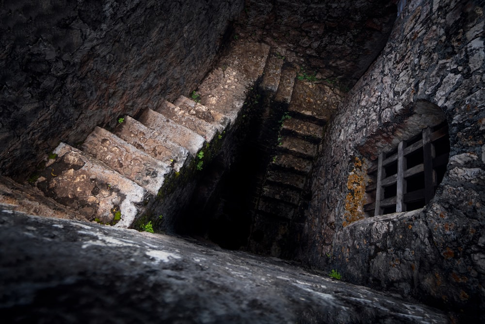 a stone building that has a rocky cliff