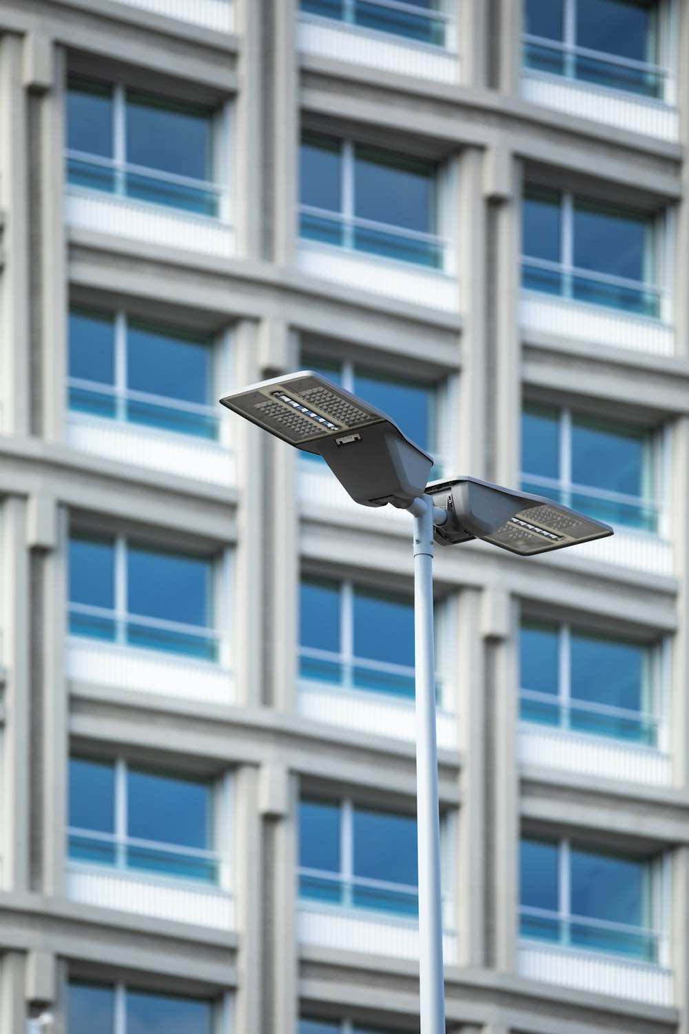 a street light with a building in the background