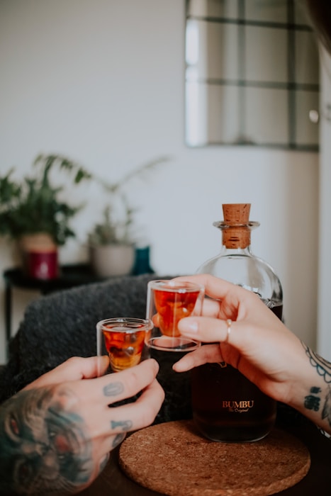 a person holding a bottle of alcohol