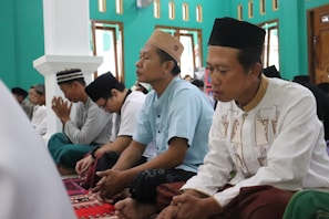 A group of kollel avreichim engaged in deep Torah study inside a warm, sunlit room.