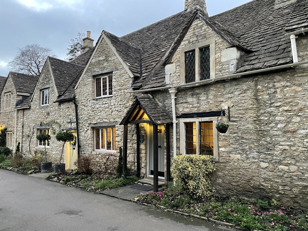 a stone house with a driveway