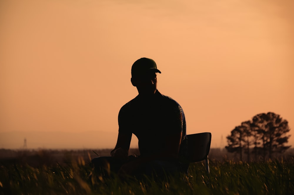 a man sitting in a field