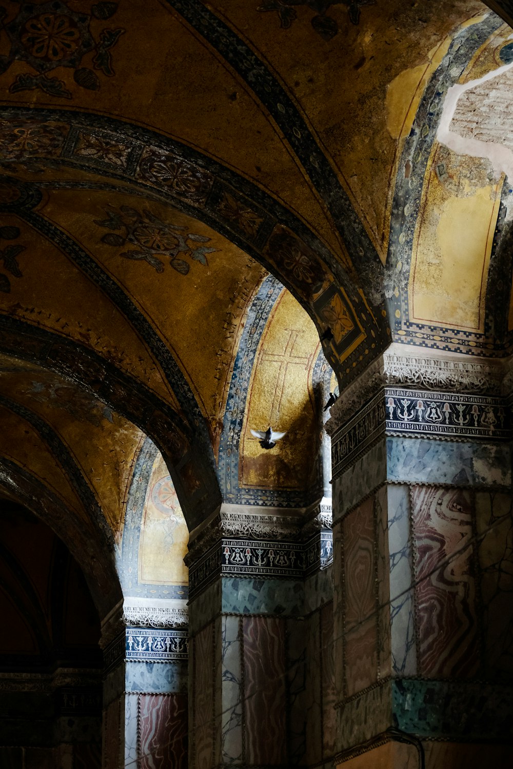 a large ornate building with paintings on the walls