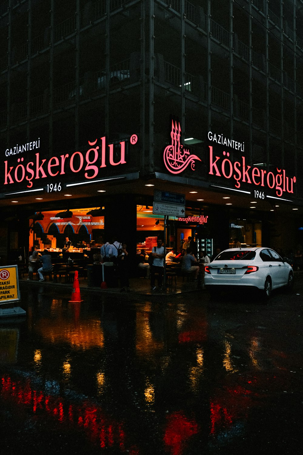 a sign on a rainy night