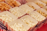 A vibrant assortment of popcorn flavors in colorful containers arranged neatly.