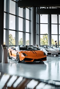a yellow sports car parked in a room with a large window