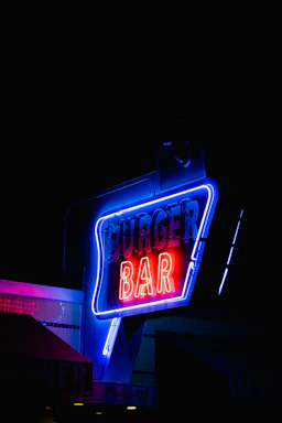 A cozy corner of Burgaroo with a glowing neon sign and a phone receiver icon.