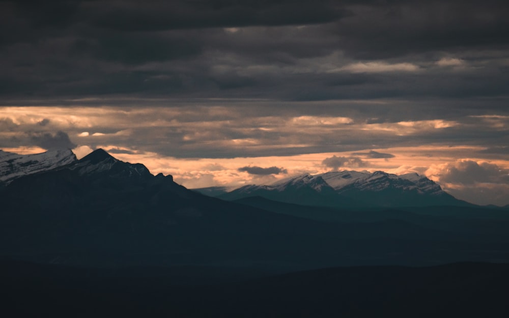 a mountain range with clouds