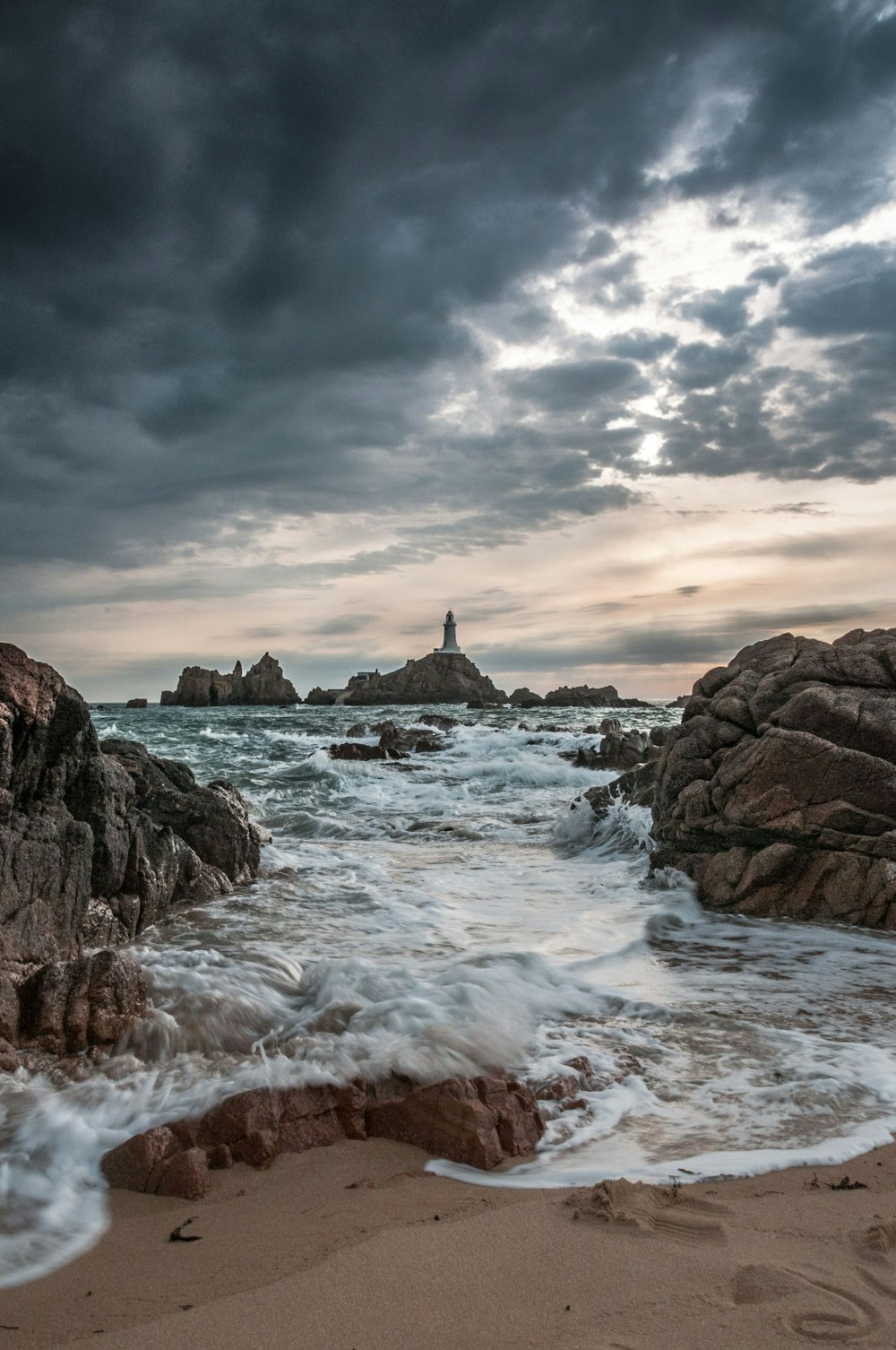 a rocky beach with waves crashing against it