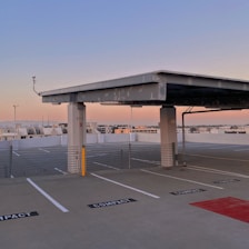 a large concrete structure with a road and a parking lot