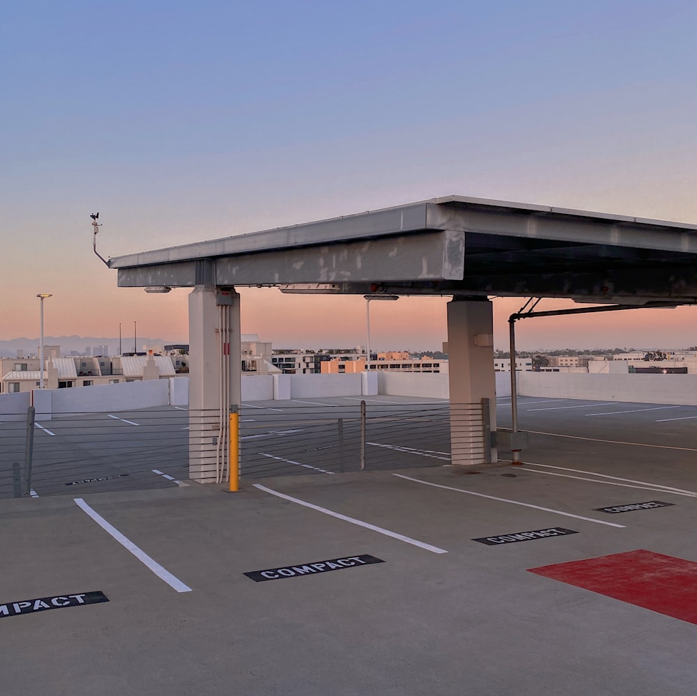 a large concrete structure with a road and a parking lot