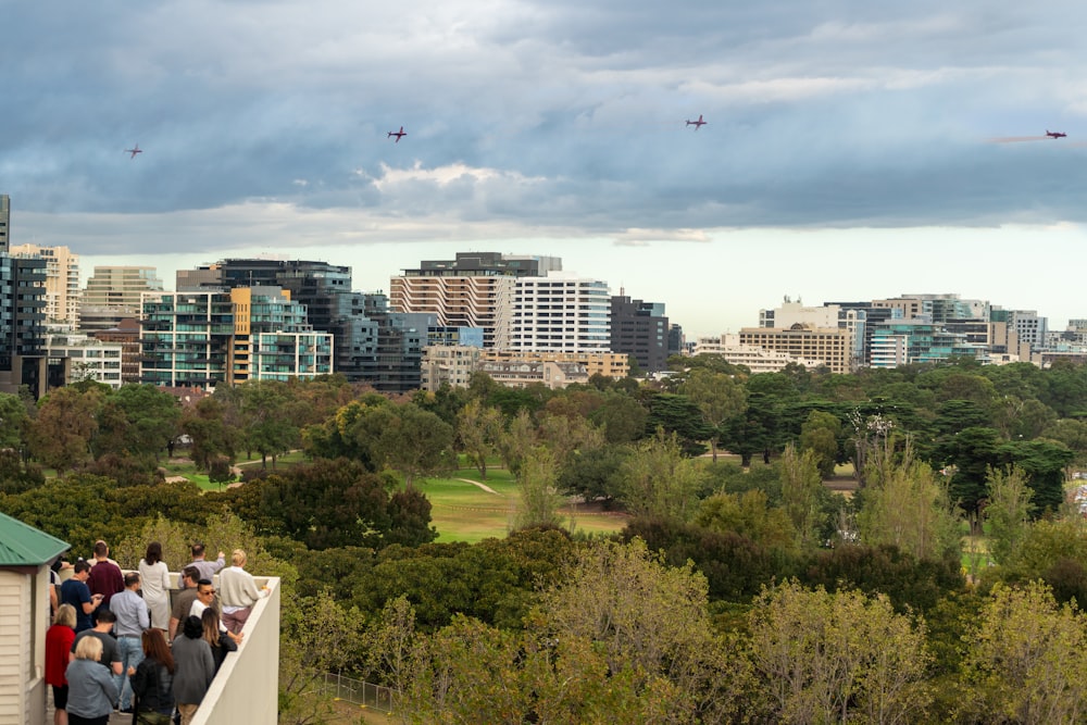 a group of people flying kites