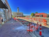 a brick road with construction cones