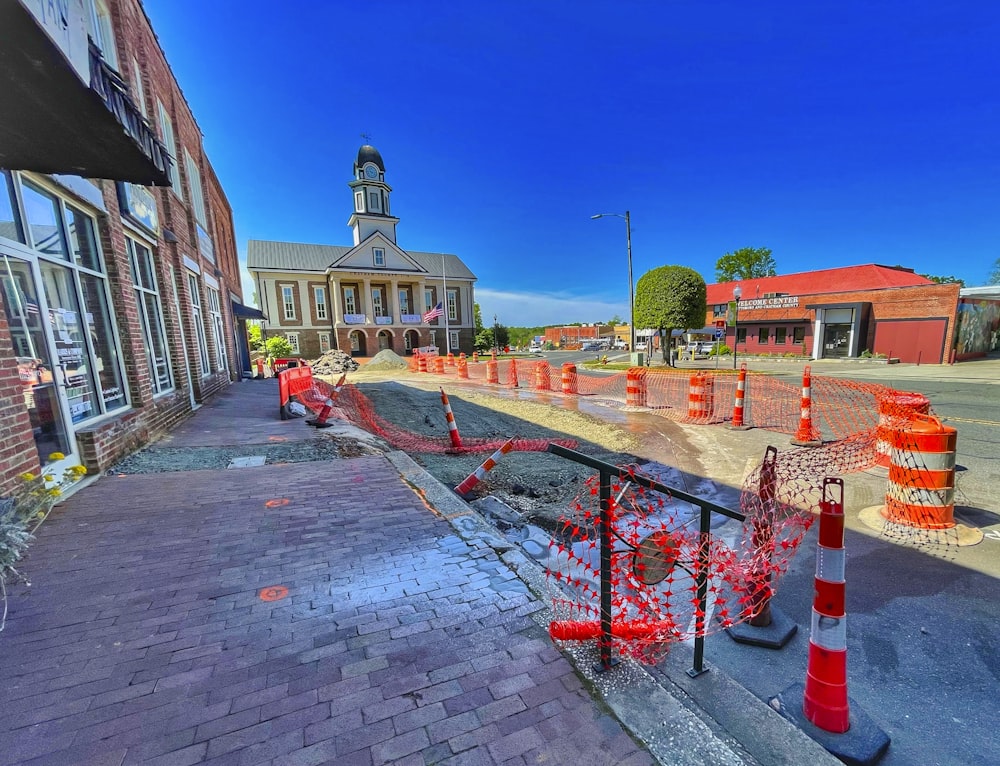 a brick road with construction cones