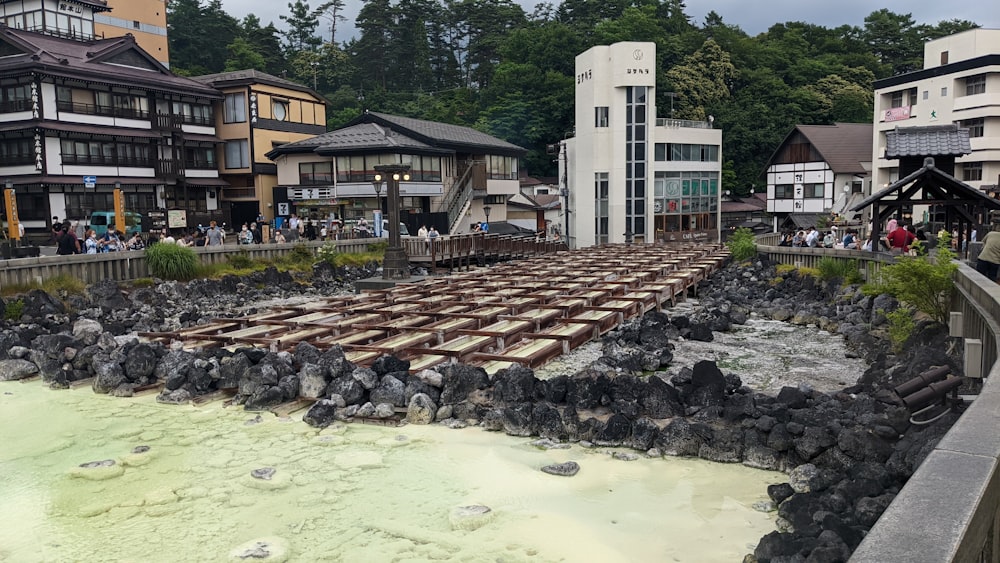 a river with rocks and buildings along it