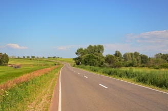 A peaceful countryside view with one of our vehicles parked beside a winding road