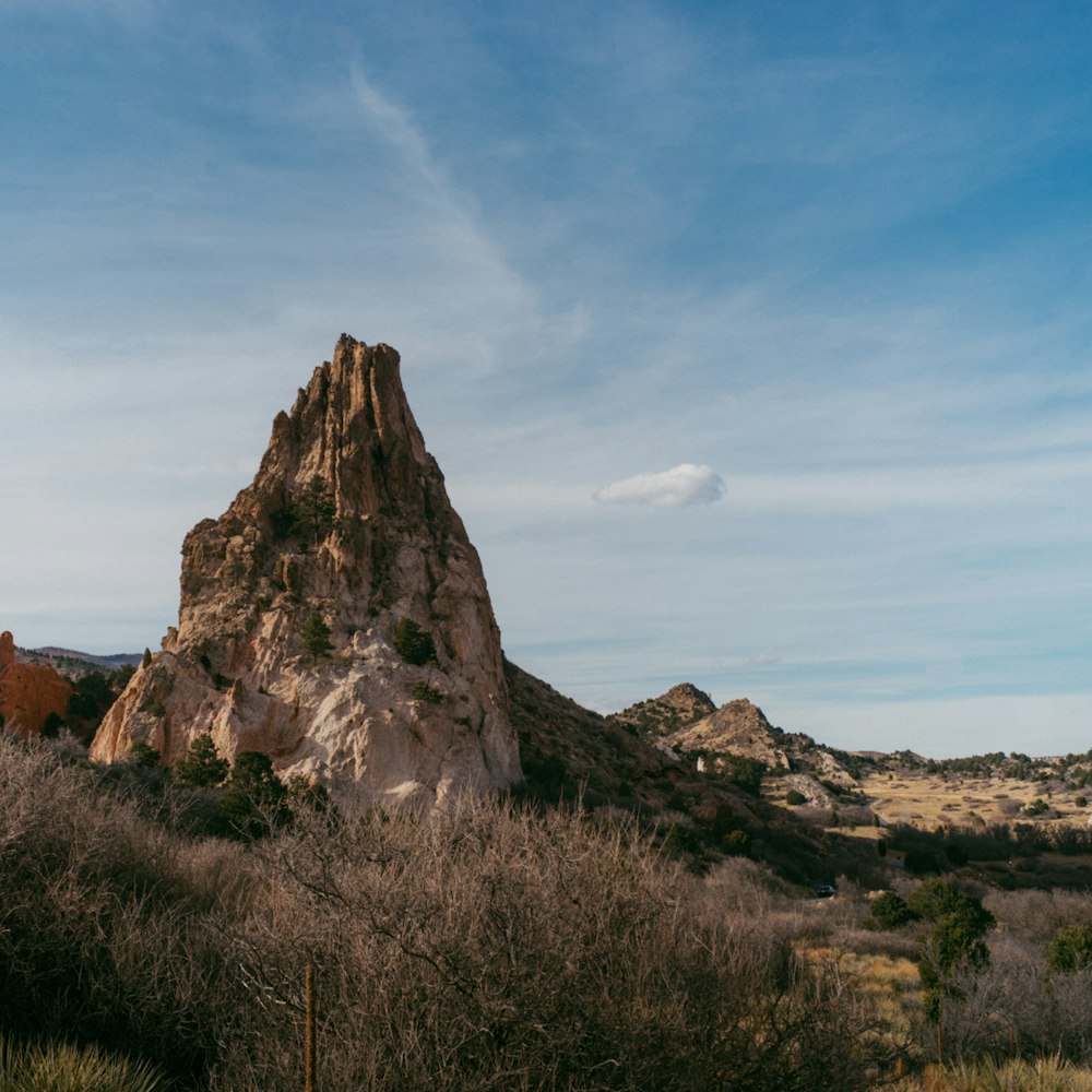 a tall rock formation in the middle of a desert