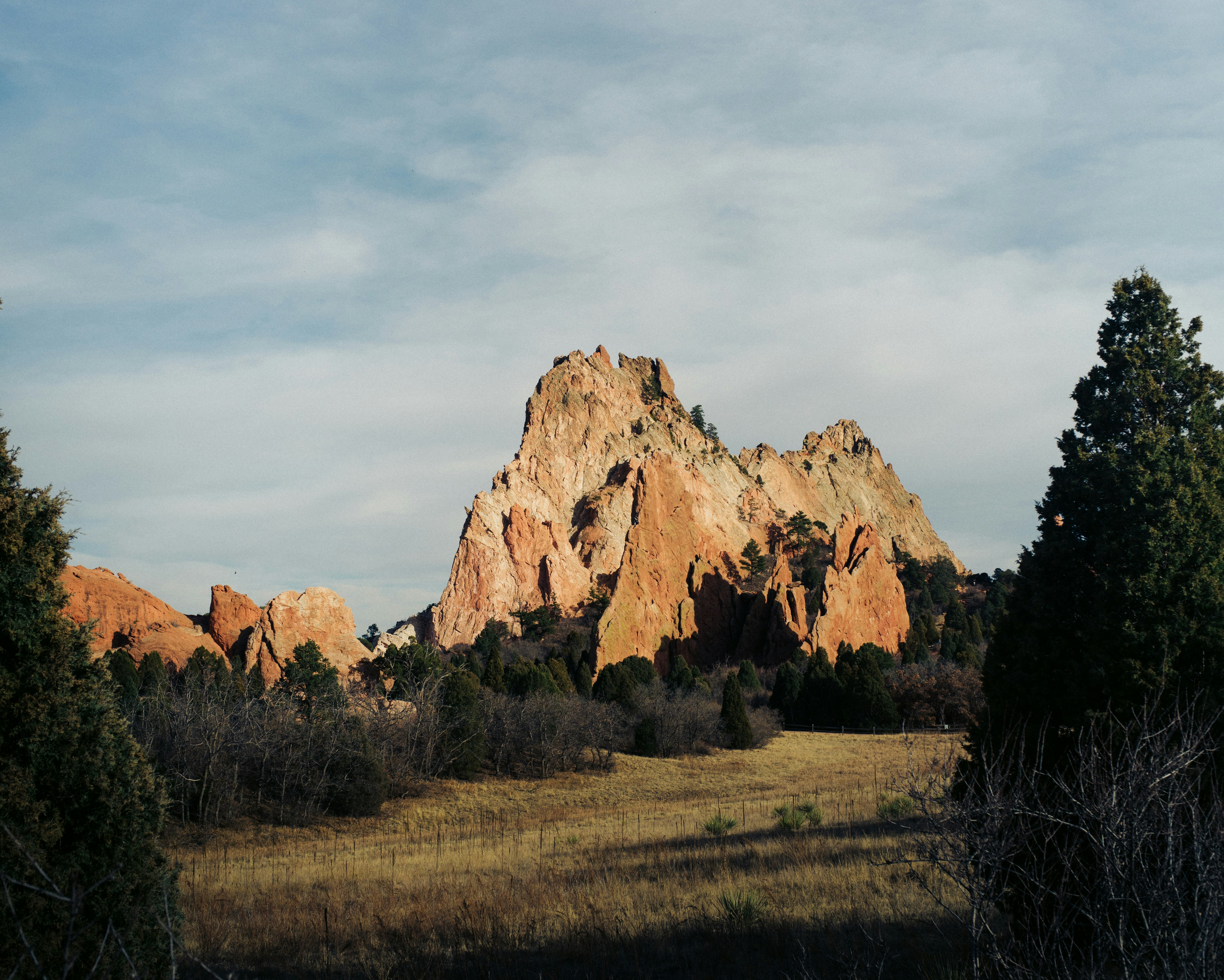 a large rock formation in the middle of a field