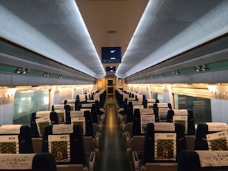 Interior view of the bullet train showcasing comfortable, modern seating and large windows.
