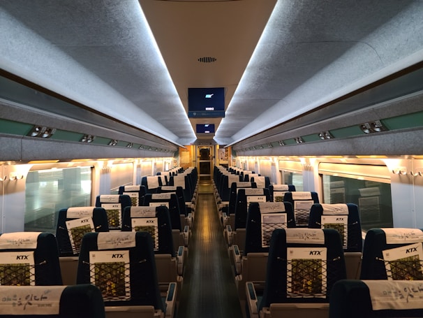 Interior view of the bullet train showcasing comfortable, modern seating and large windows.