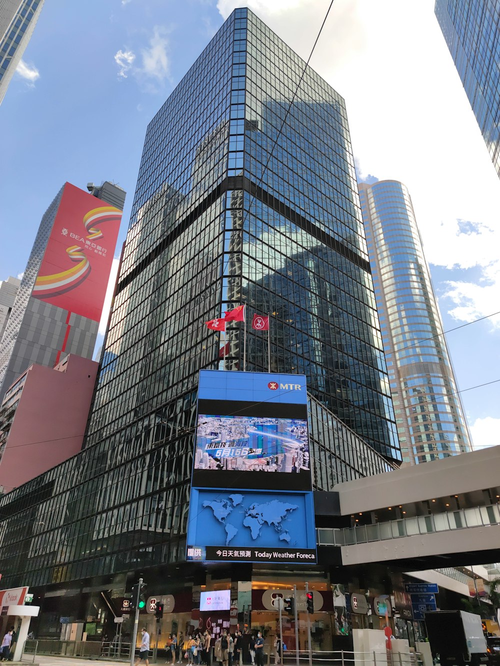 a large glass building with a sign on it