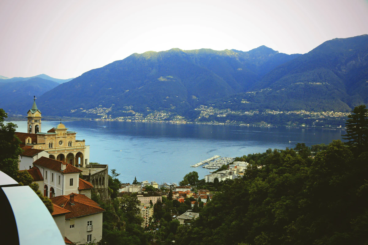 A church on the hillside above Locarno, with Lago Maggiore and mountains behind