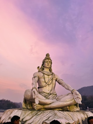 A serene and devotional image of Lord Shiva meditating in the Himalayas at dawn.