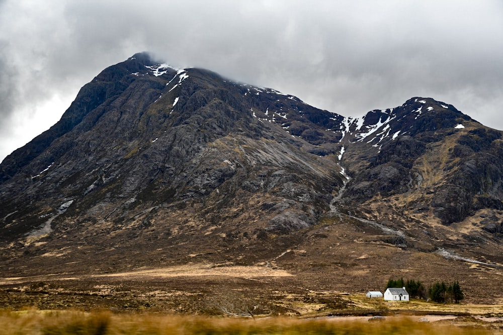 a house in front of a mountain