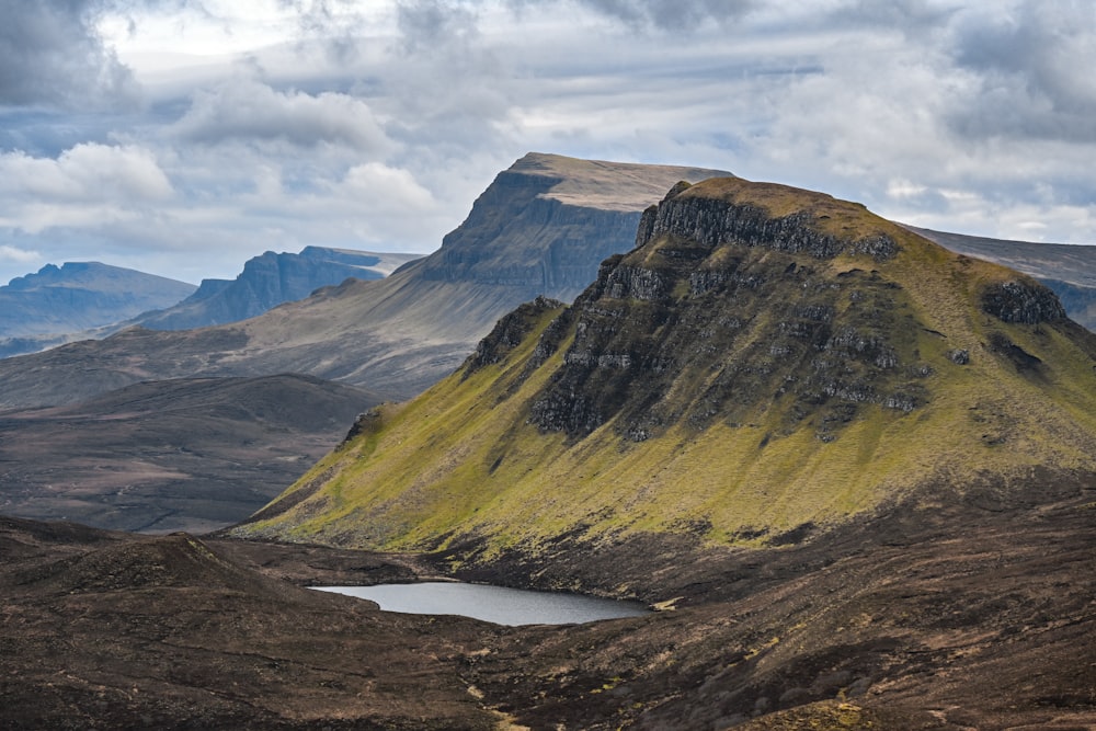 a mountain with a small pond in the middle