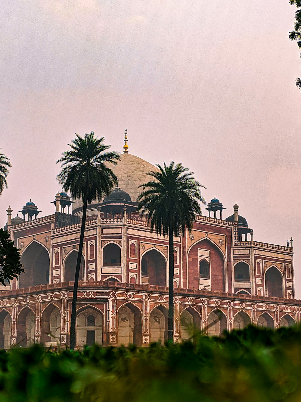 a large building with palm trees in front of it