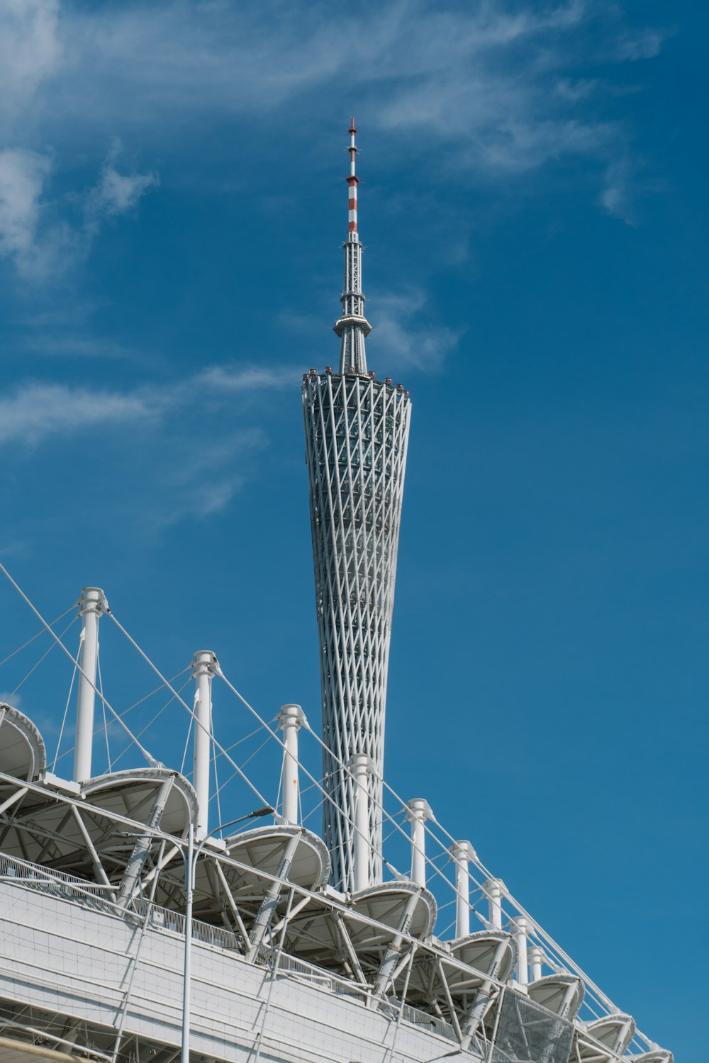 a tall tower with a blue sky with Tokyo Skytree in the background