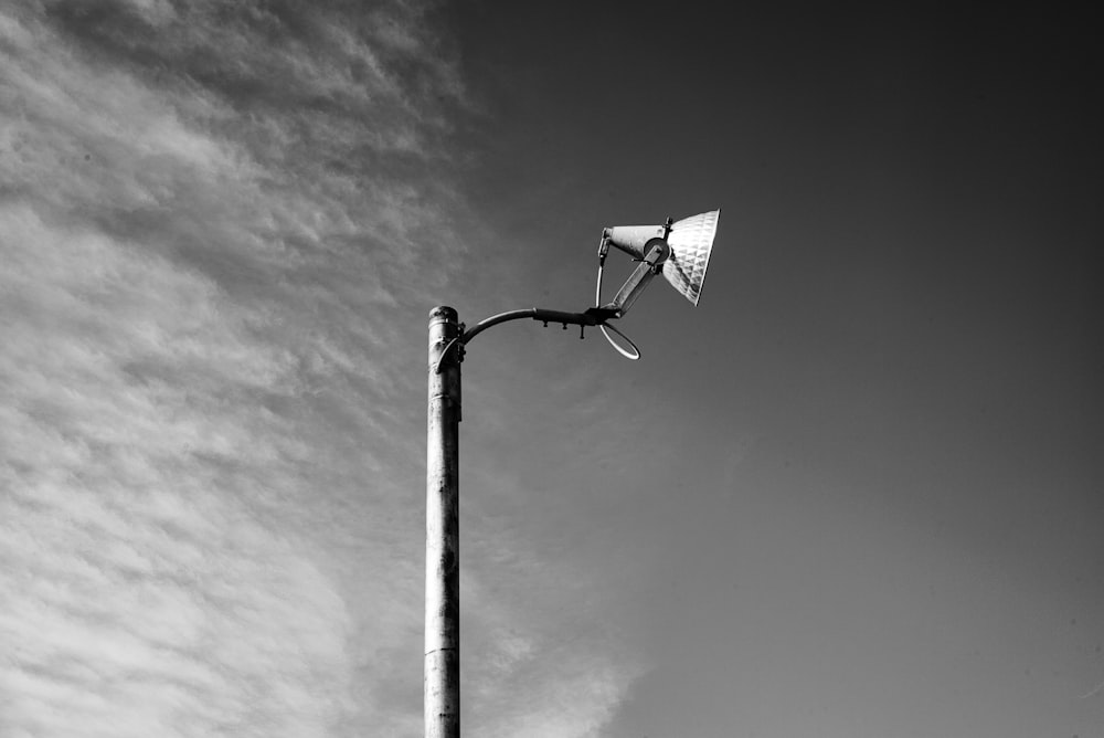 a street light with a cloudy sky