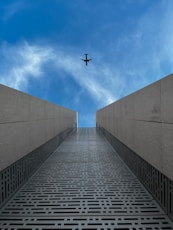 a plane flying over a bridge