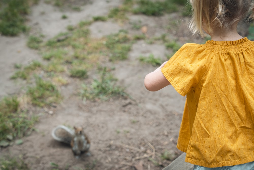 a child looking at a squirrel
