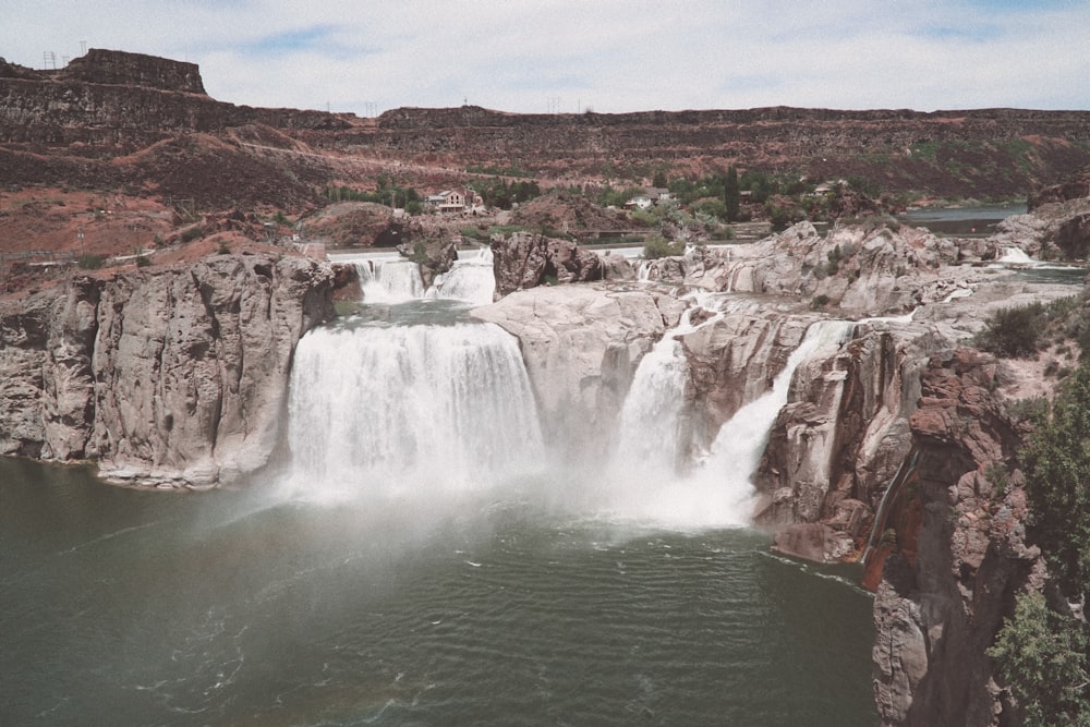 a waterfall with a town in the background