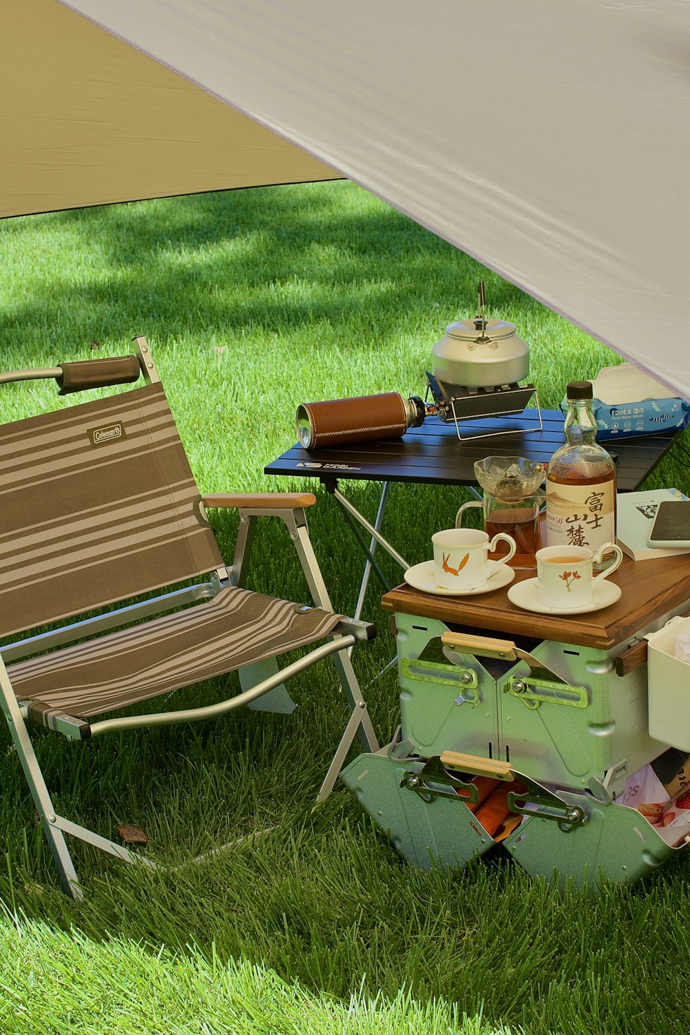 a table with a chair and a chair in a grassy area