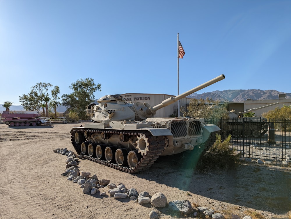 a military tank parked on a dirt road