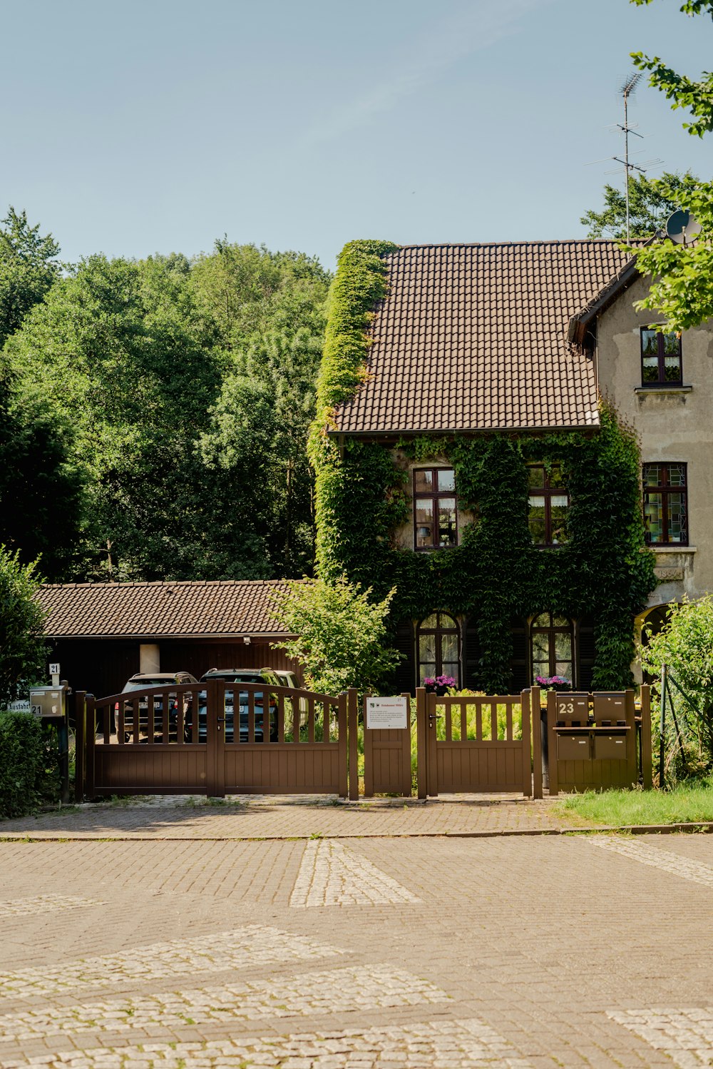 a brick house with a fence in front of it