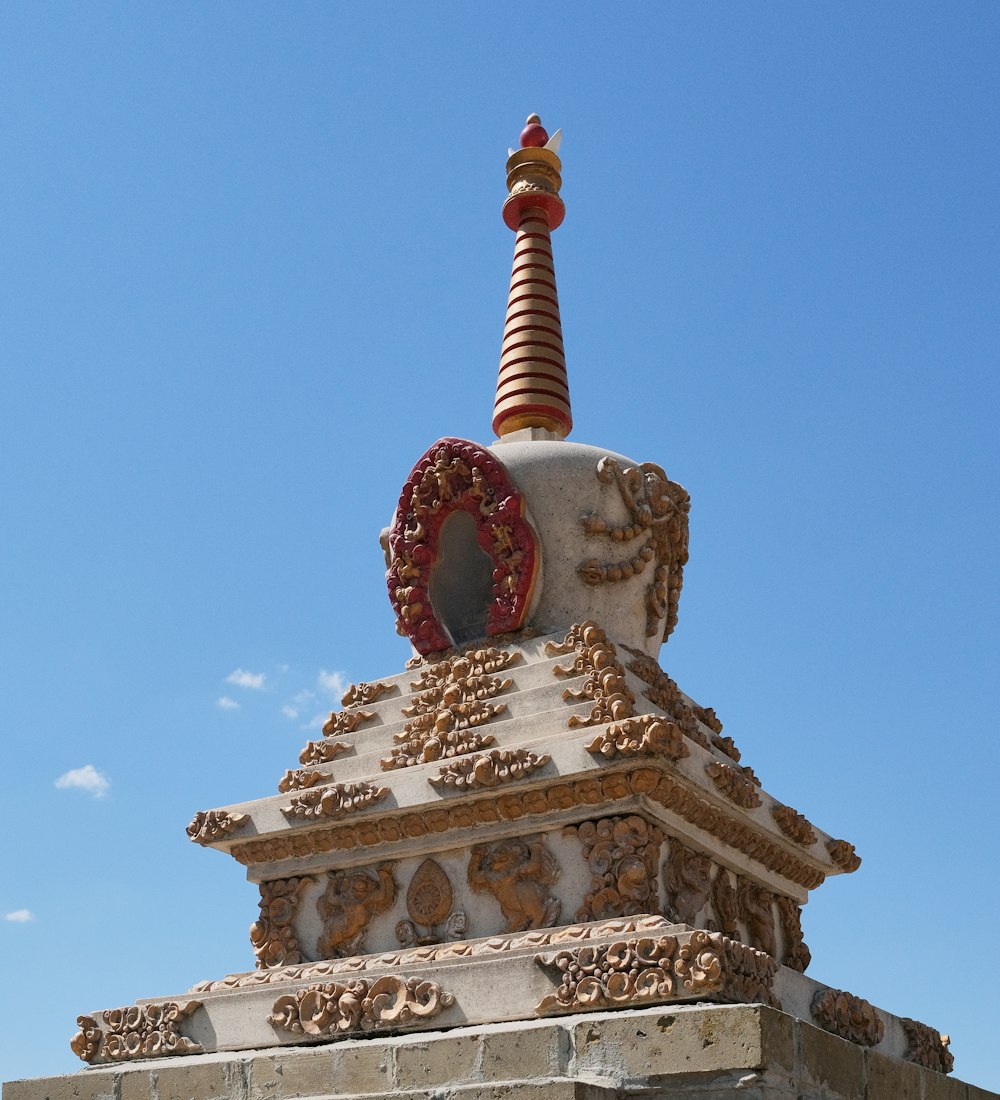 a stone building with a statue on top