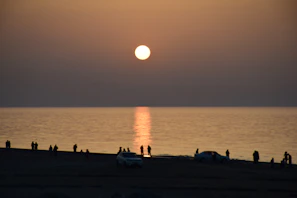 Tourists enjoying a peaceful sunset over the Gulf of Nicoya waters.