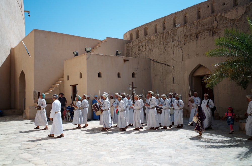 a group of people in white robes