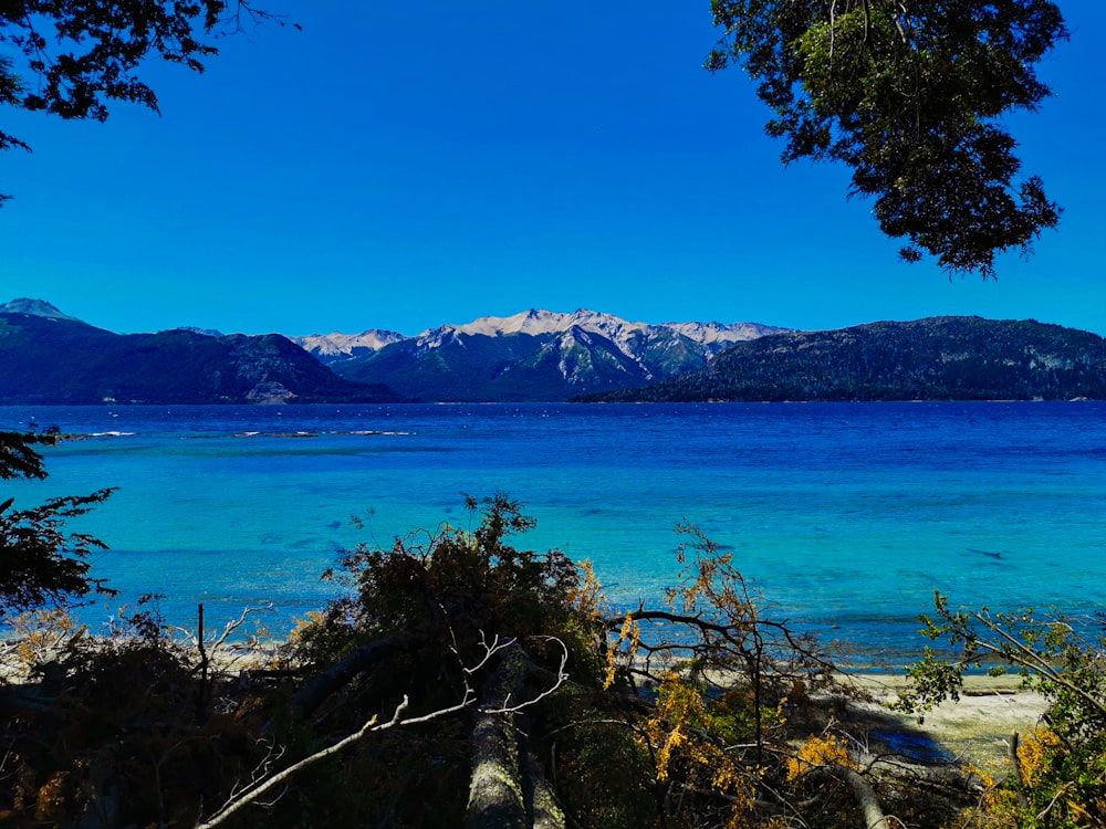 a body of water with mountains in the background