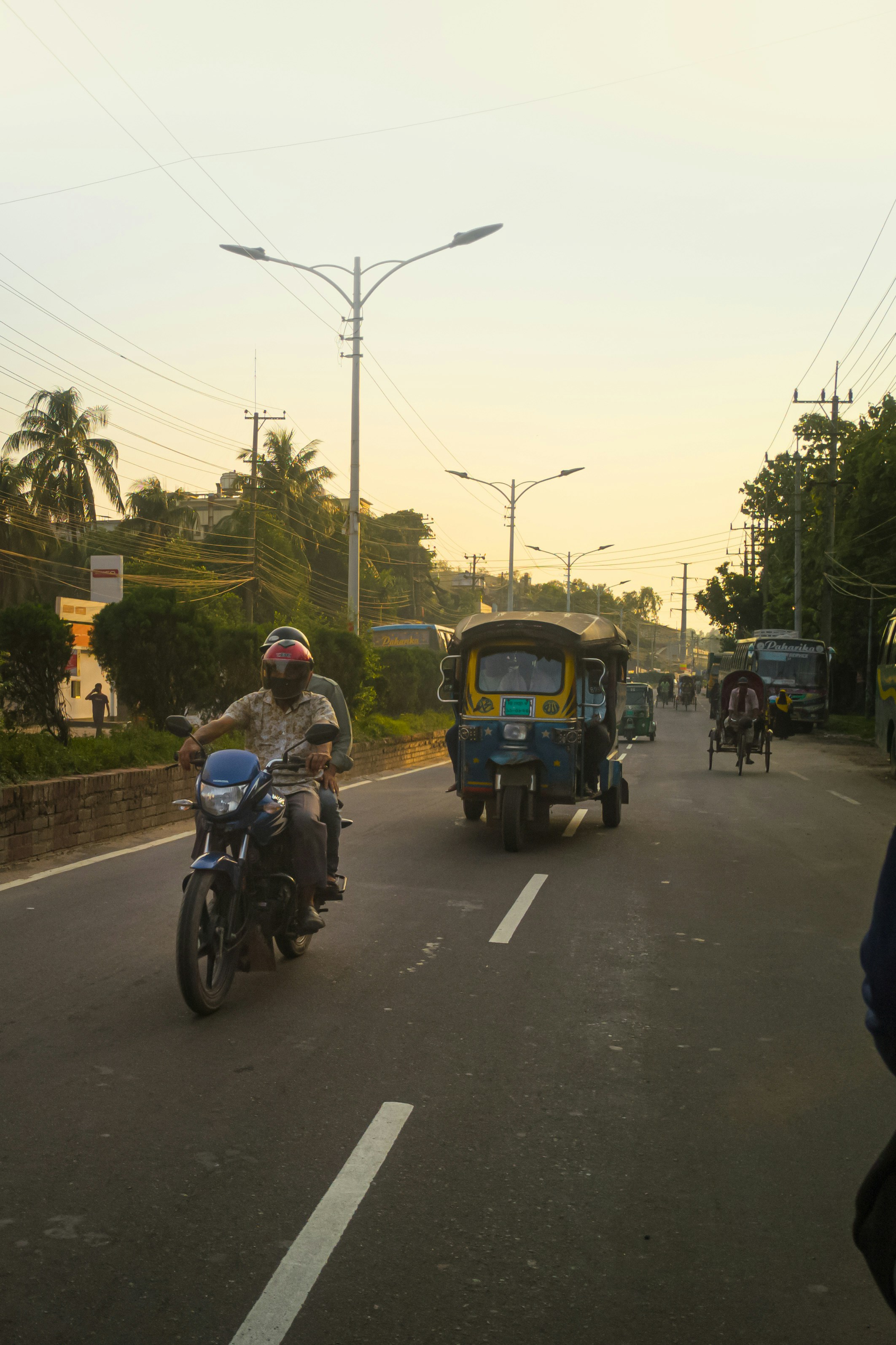 a man riding a motorcycle down the street