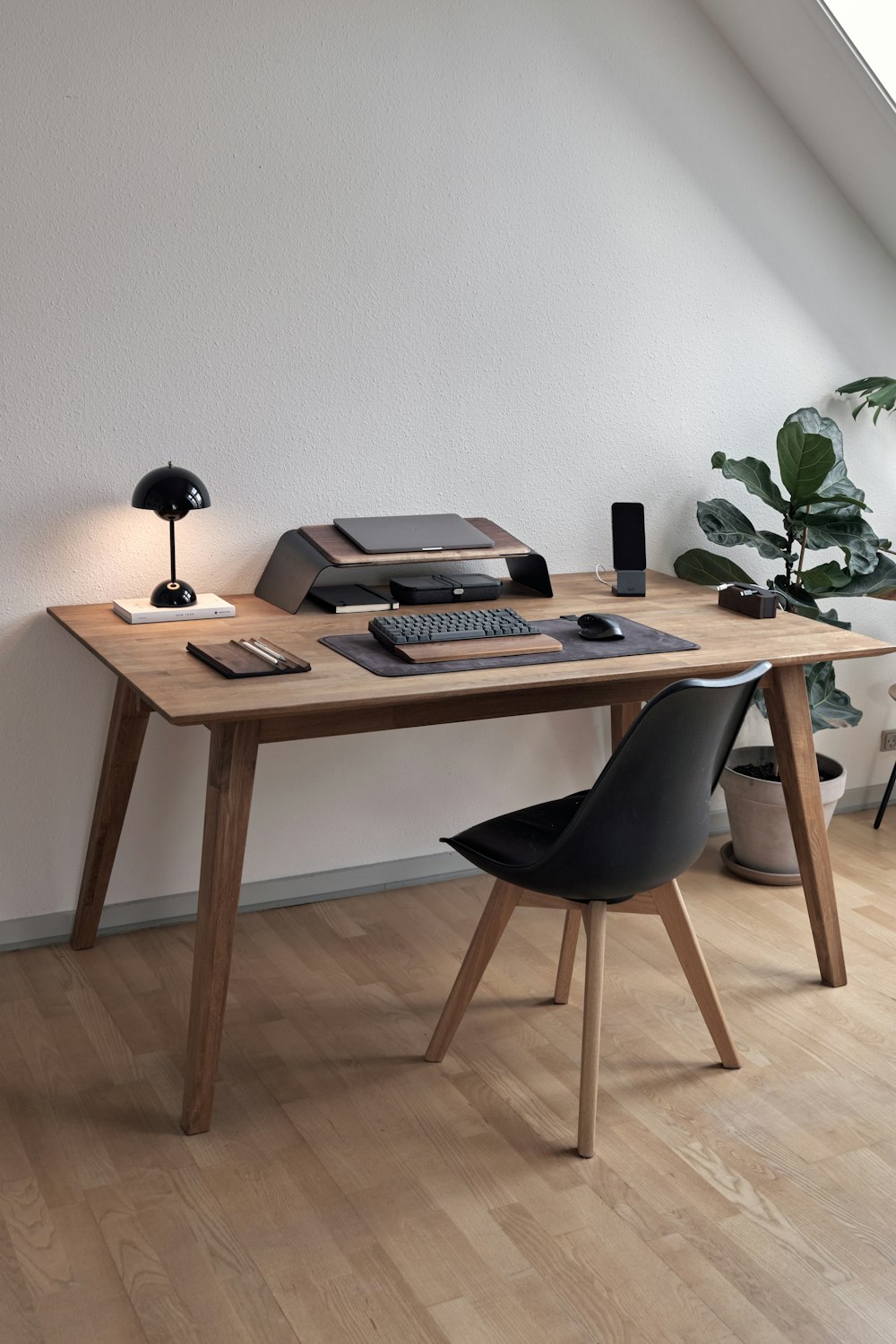 a desk with a computer and a chair